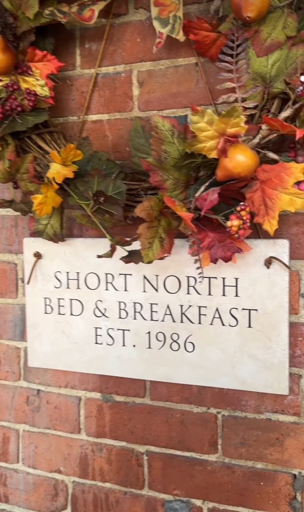 Sign of "Short North Bed & Breakfast" with decorative autumn leaves, established in 1986.